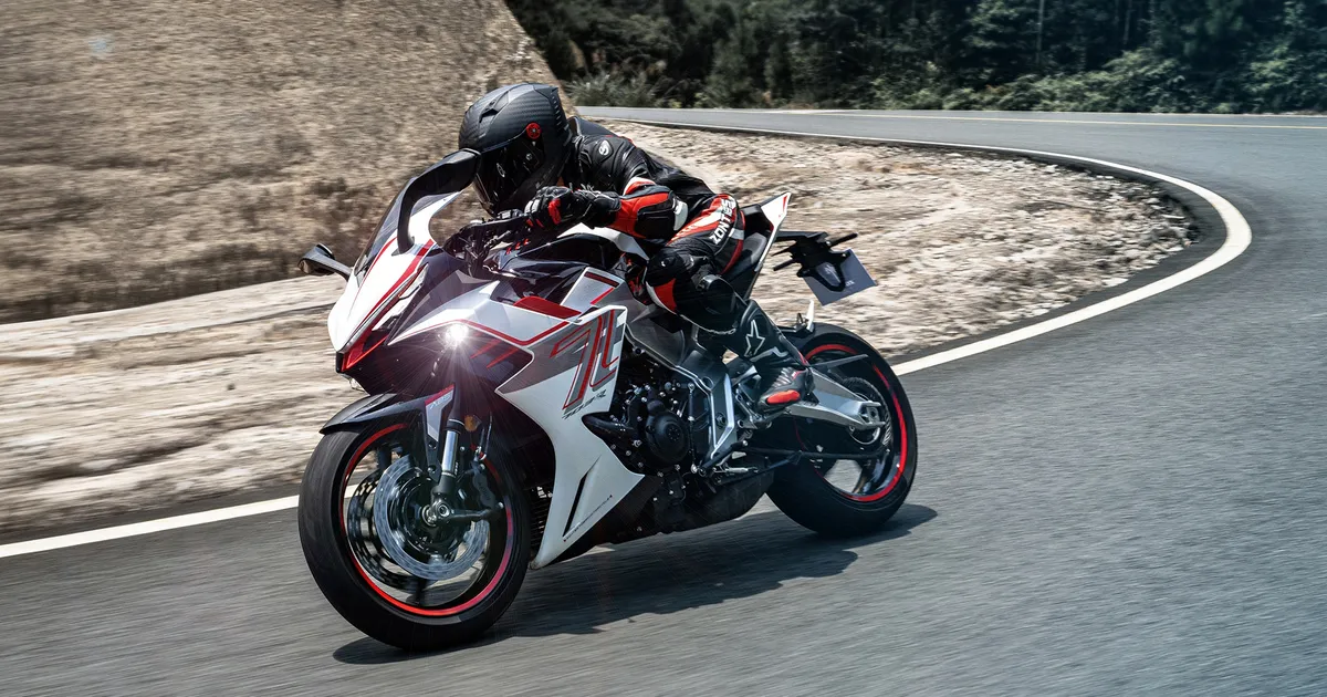 The Zontes 703RR leaned into a corner on a mountain road, official manufacturer photo